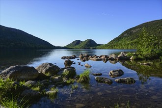 Rocks in Jordan Pond by hills in Acadia National Park, Maine, USA