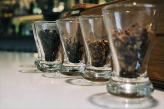Row of glasses containing spices