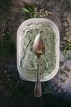 Spoon on mint chocolate ice cream with flowers