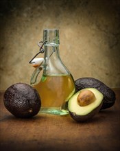 Avocados with bottle of oil