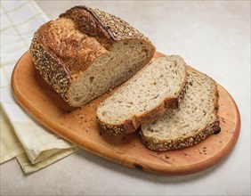 Sliced  loaf of bread on cutting board