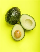 Avocados on green surface