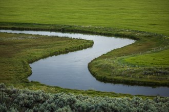 River through fields in Picabo, Idaho, USA
