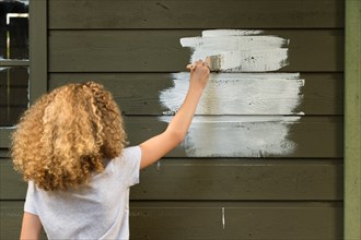 Girl painting house