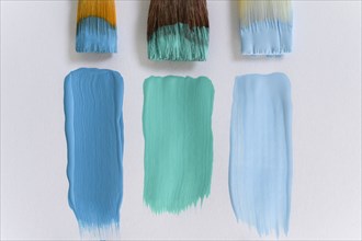 Paintbrushes and blue brushstrokes