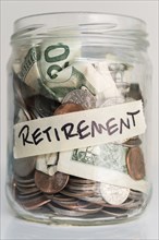 Money in jar labeled 'retirement'