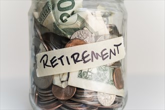 Money in jar labeled 'retirement'
