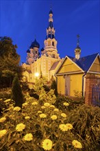 Flowers by St. Nicholas Church at night in Brest, Belarus