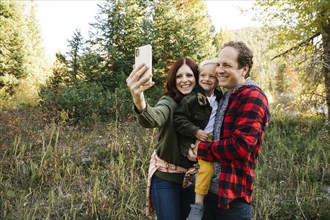Family taking selfie in forest