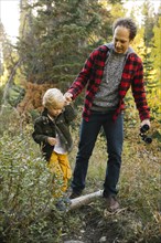 Father and son in forest
