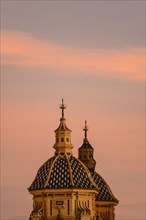 Domes of Church of Saint Louis of France at sunset in Seville, Andalusia, Spain