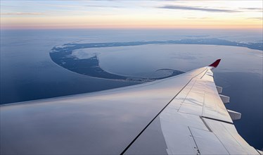 Airplane wing against aerial view of Lower Cape Cod, Massachusetts, USA