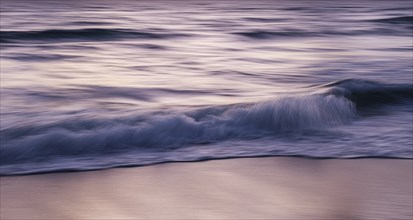 Blurred image of waves on beach