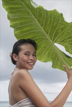 Woman holding big leaf