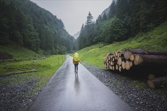 Woman hiking on road in Appenzell Alps, Switzerland