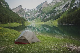 Tent by Seealpsee lake in Appenzell Alps, Switzerland