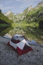 Tent by Seealpsee lake in Appenzell Alps, Switzerland