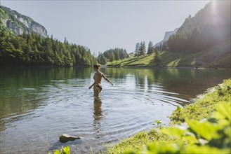 Woman swimming in Seealpsee lake in Appenzell Alps, Switzerland