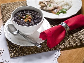Beans in bowl with spoon and red napkin