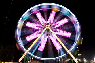 Blurred image of Ferris wheel at night at Santa's Enchanted Forest in Miami, Florida, USA