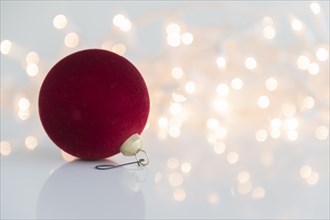 Red bauble against lights