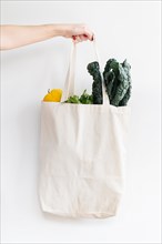 Woman holding bag of vegetables