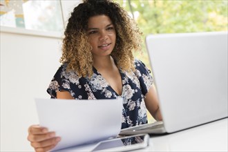 Smiling woman working on laptop