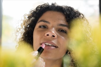 Woman applying lipstick