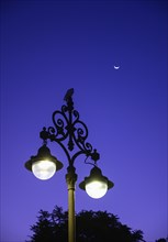 Illuminated street light at night in Seville, Spain