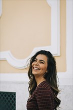 Smiling woman by wall