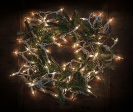 Wreath made from pine fronds, sticks and fairy lights