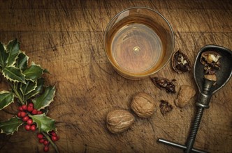 Mistletoe, drink in glass, walnuts and nut cracker