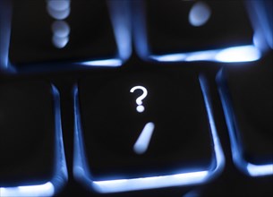Illuminated question mark key on keyboard