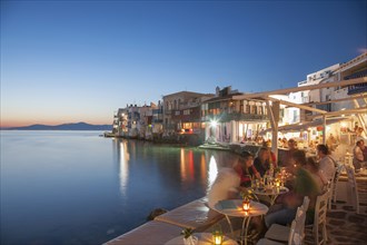 Waterfront restaurants at night in Mykonos, Greece
