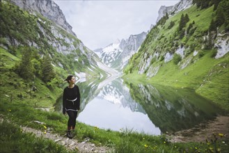 Woman by mountains and lake in Appenzell, Switzerland