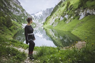 Woman by mountains and lake in Appenzell, Switzerland