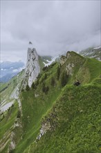 Woman sitting on mountain in Appenzell, Switzerland