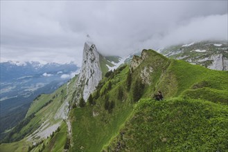Woman sitting on mountain in Appenzell, Switzerland