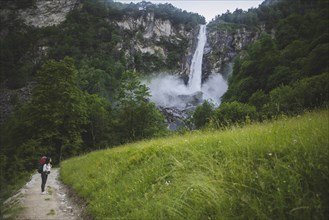 Woman on path to waterfall