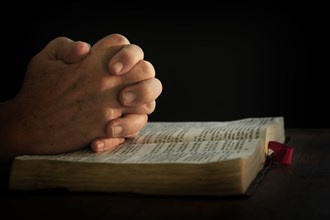 Man's hands on open bible