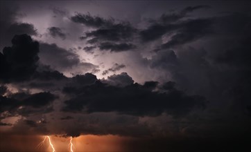 Lightning and storm clouds in sky