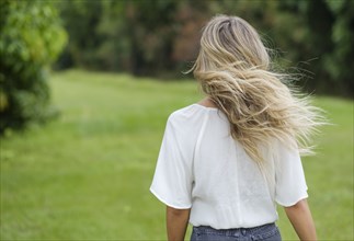 Rear view of young woman with windswept hair