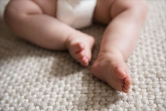 Baby's bare feet on carpet