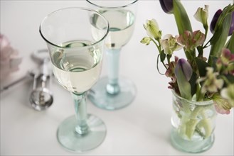 Glasses of white wine and flowers