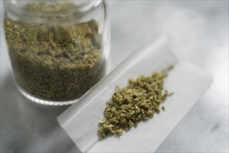 Marijuana in rolling paper and glass jar