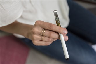 Hand of woman holding electronic cigarette