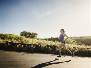 Woman jogging on rural road