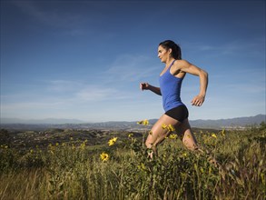 Woman jogging in meadow