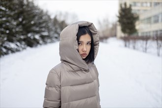 young woman in hooded jacket during winter