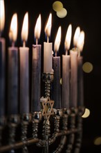 Lit candles in menorah